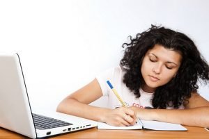 girl is writing her academic essay